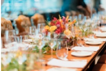 A long table is set up for a wedding reception, where two-way radios are being used.